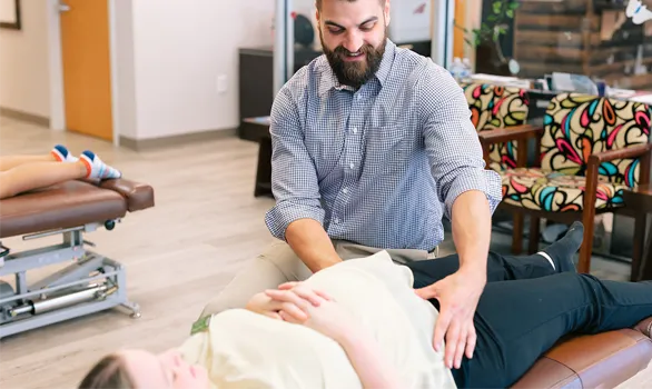 Pediatric Chiropractor Roswell GA Steven Lako Adjusting A Pregnant Patient